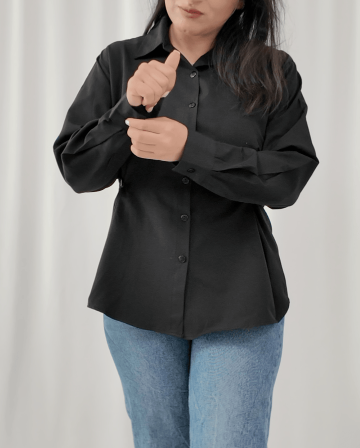 Close-up of cotton fabric and side buttons on Noir Elegance shirt
